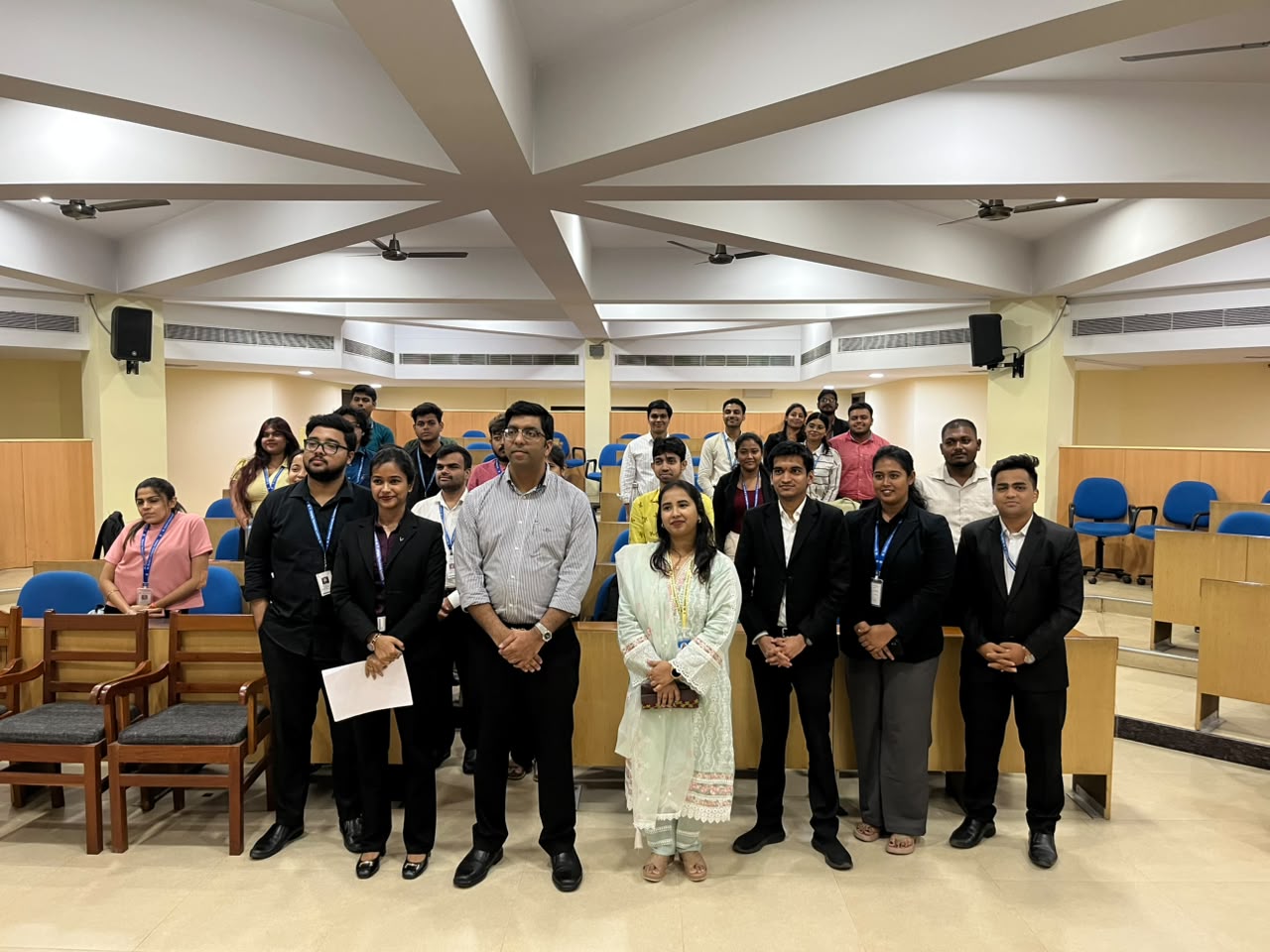 Group photo with a cohort in a lecture auditorium after a session